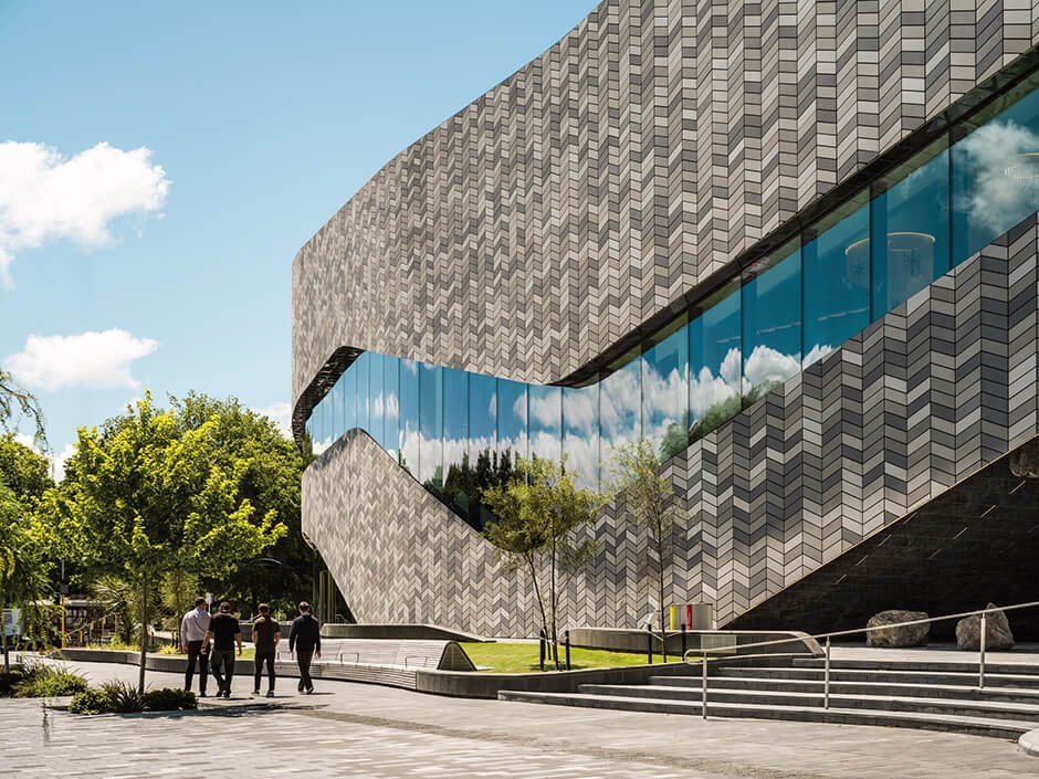 Tiled facade wraps curved convention centre by Woods Bagot and Warren & Mahoney