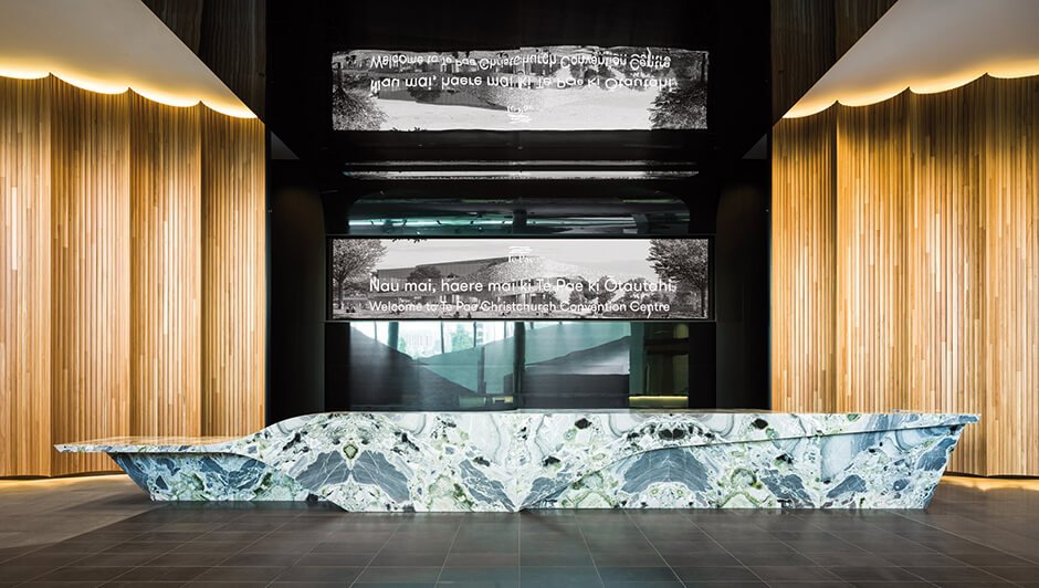 Tiled facade wraps curved convention centre by Woods Bagot and Warren & Mahoney