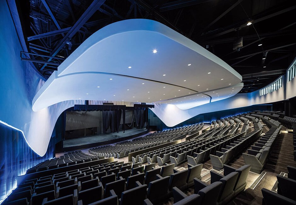 Tiled facade wraps curved convention centre by Woods Bagot and Warren & Mahoney