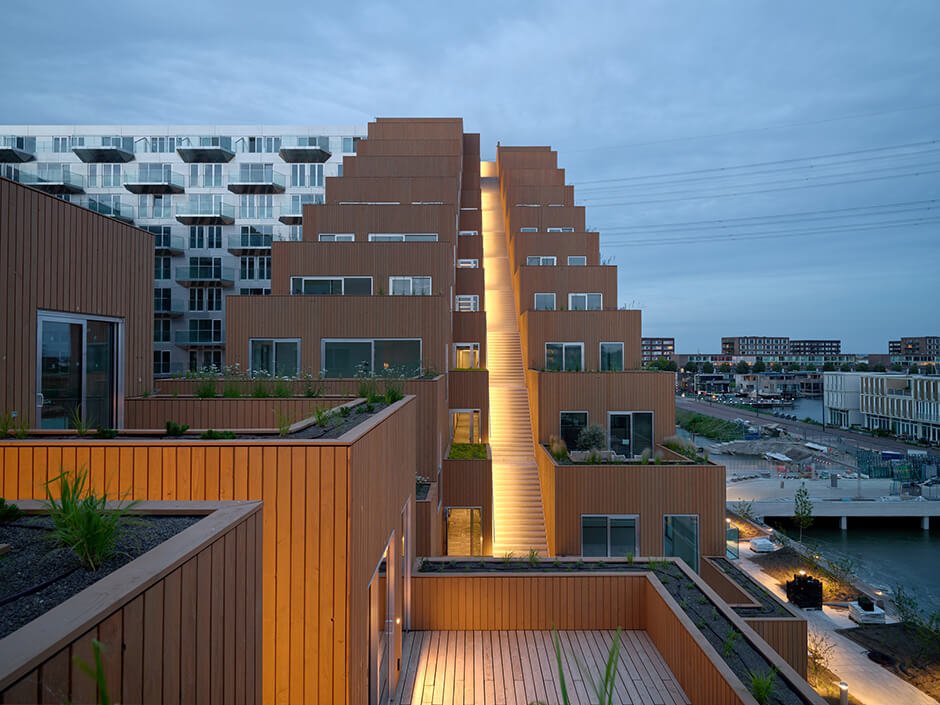 BIG and Barcode Architects cantilever housing block over IJ lake in Amsterdam