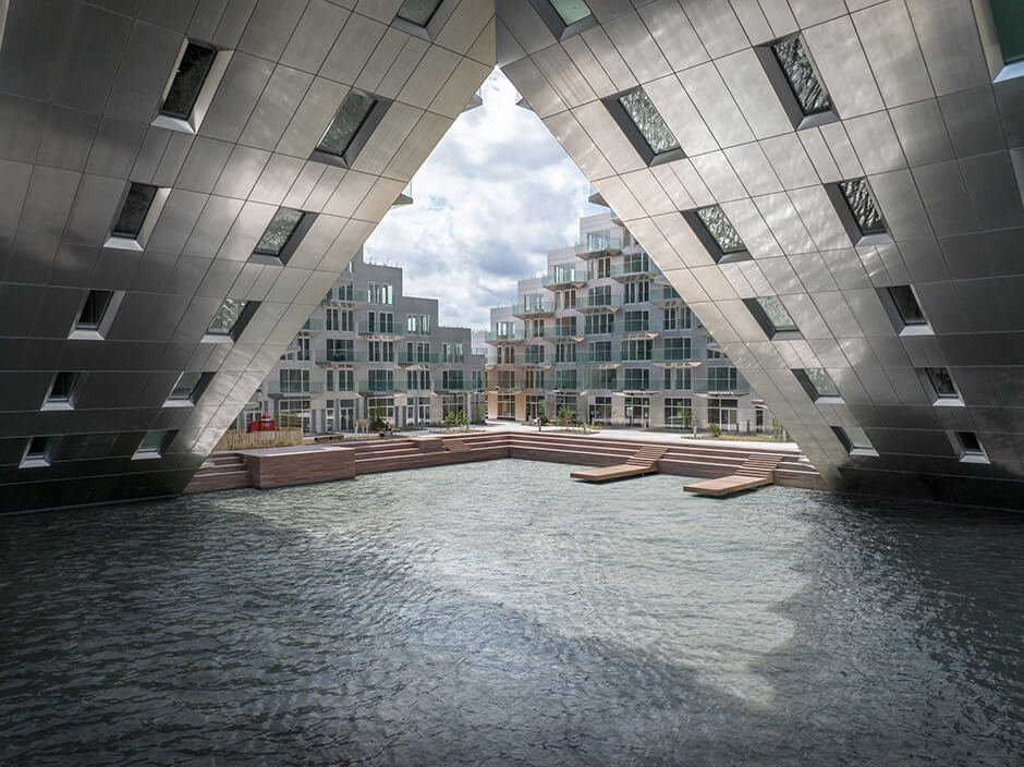 BIG and Barcode Architects cantilever housing block over IJ lake in Amsterdam