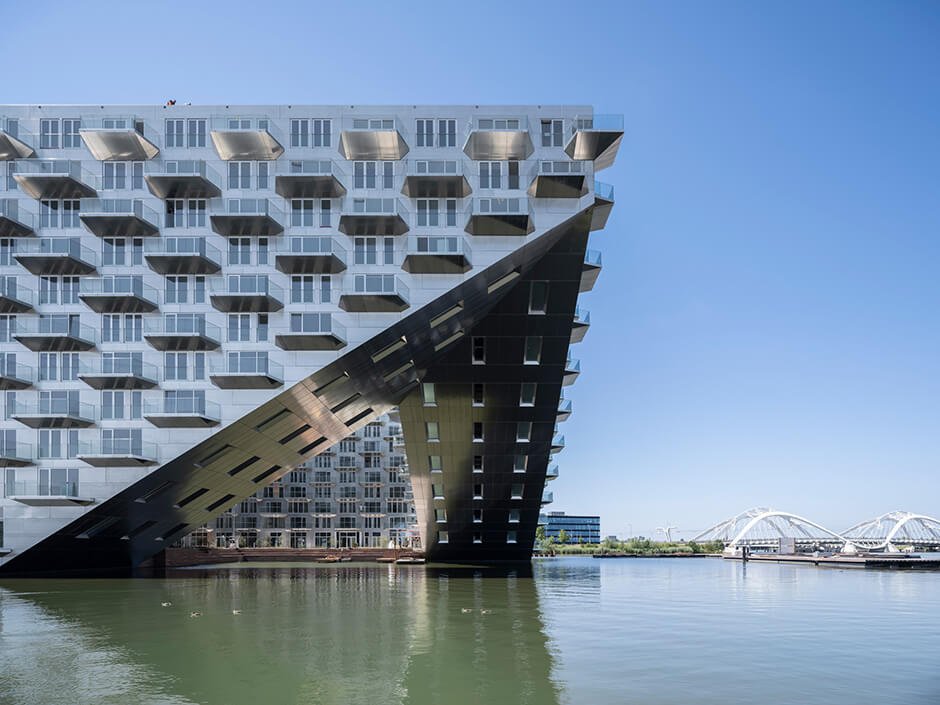 BIG and Barcode Architects cantilever housing block over IJ lake in Amsterdam